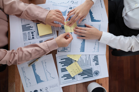 Top view analyst team colleagues discuss financial data on digital dashboard, analyzing charts and graph. Professional office use business intelligence to plan marketing. Enthusiasticの写真素材