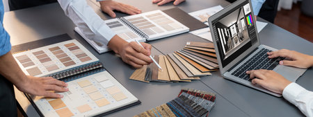 Group of interior architect designer team at table choosing various mood board samples with...