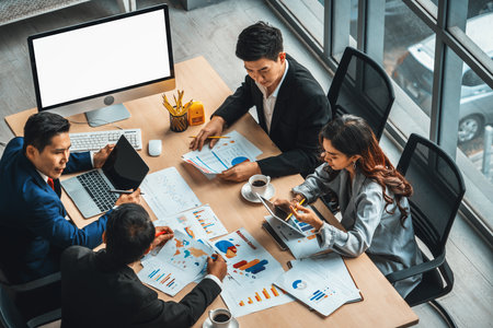 Business people group meeting shot from top view in office . Profession businesswomen, businessmen and office workers working in team conference with project planning document on meeting table . Jivyの写真素材