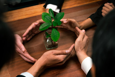 Business people holding money savings jar together in synergy filled with coin and growing plant for sustainable financial for retirement or eco subsidy investment for environment protection. Quaintの写真素材