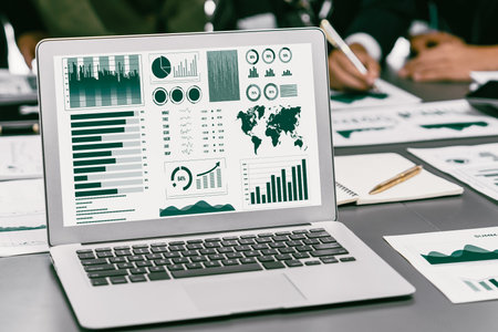 Panorama shot analyst team utilizing BI Fintech to analyze financial report with laptop. Businesspeople analyzing BI data dashboard displayed on laptop screen for business insight. Prodigyの写真素材