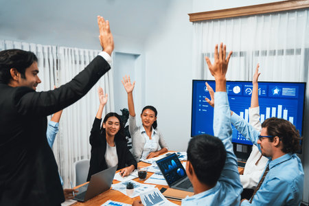 Group of happy multi ethnic businesspeople in celebratory gesture and successful teamwork after made...