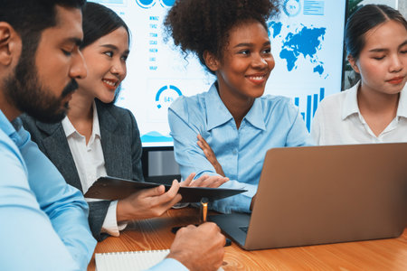 Multiracial analyst team use BI dashboard data to analyze financial report on meeting table. Group of diverse business people utilize data analysis by FIntech for success business marketing. Concordの写真素材