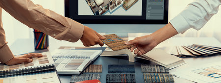 Group of interior architect designer team at table choosing various mood board samples with architecture software on laptop screen. Modern renovation and interior material selection concept. Insightの写真素材
