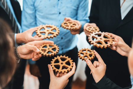 Group of multiracial business people joining gear wheels together as effective unity and productive teamwork concept. Efficient system business team process for solution solving. Meticulousの写真素材