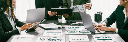Analyst team working on BI Fintech to analyze financial dashboard paper at office workplace. Businesspeople reviewing report paper on table for business insight. Panorama shot. Prodigyの写真素材