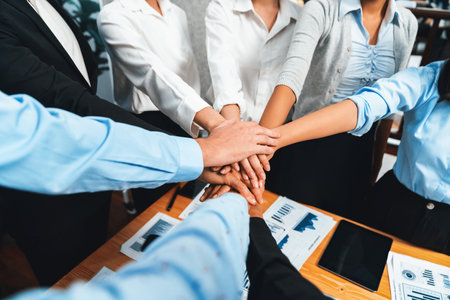 Multiracial business people make synergy hand stack together in meeting room as cooperation or team building for corporate employee in workplace. Meticulousの写真素材