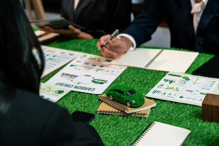 Group of business people planning strategic marketing in electric car company meeting for eco-friendly EV car using sustainable and alternative power contribute to greener future. Quaintの写真素材