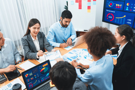 Multiracial analyst team use BI Fintech software to analyze financial data on meeting table....