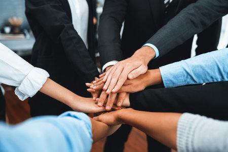 Multiracial business people make synergy hand stack together in meeting room as cooperation or team building for corporate employee in workplace. Meticulousの写真素材