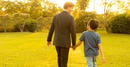 Visionary and eco conscious businessman father guide his son to the bright future with sunset setting using clean alternative energy and sustainable environmental paving way to promising tomorrow.Gyreの写真素材