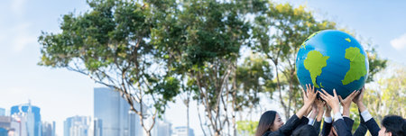 Earth day concept with big Earth globe held by group of asian business people team promoting...