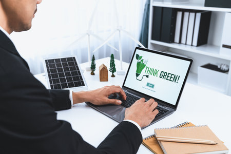 Businessman working in office developing plan or project on eco-friendly alternative energy with...