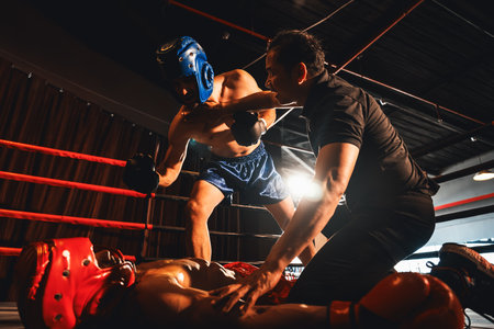 Boxing referee intervene, halting the fight to check fallen competitor after knock out. Intense and fierce boxing match with referee pauses the action for boxer fighters safety after KO. Impetusの写真素材