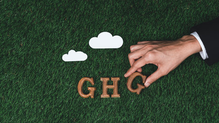Hand arrange wooden alphabet text in GHG on biophilic background with greenhouse gases icon as eco symbol for encouraging message for greenhouse reduction campaign and environmental awareness. Gyreの写真素材