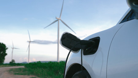 Progressive future energy infrastructure concept of electric vehicle being charged at charging...