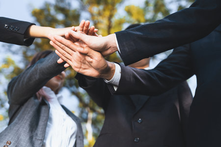 Eco business people join hand together as teamwork and unity, outdoor business volunteer mission for eco-friendly practices and collaboration in corporate social responsibility for environment. Gyreの写真素材