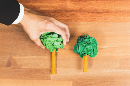 Ethical business with forest regeneration concept, top view recycle paper tree on wooden table as environmental awareness. Eco-friendly company policy and green environment effort to save Earth. Alterの写真素材