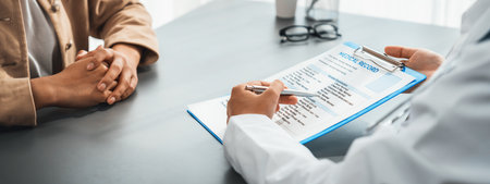 Doctor show medical diagnosis report and providing compassionate healthcare consultation to young patient in doctor clinic office. Doctor appointment and medical consult concept. Neotericの写真素材