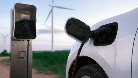 Progressive future energy infrastructure concept of electric vehicle being charged at charging...