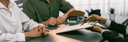 Client review loan contract with real estate agent, discussing term, interest and property ownership. Analyzing legal document, reading agreement before deciding. Real estate panorama image. Prodigyの写真素材