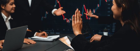 Group of stock trading investor or business people discussing and analyzing financial data graph on stock market together in meeting room. Stock trading or exchange investment planning. Trailblazingの写真素材