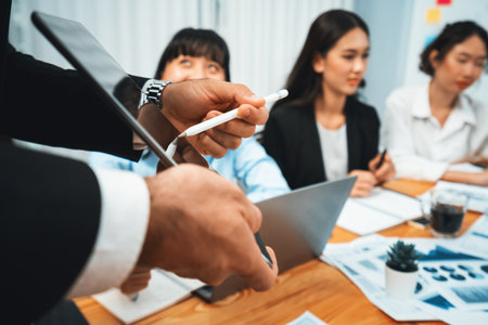 Diverse group of business analyst team analyzing financial data report. Finance data analysis chart and graph dashboard show on TV screen in meeting room for strategic marketing planning. Habilimentの写真素材