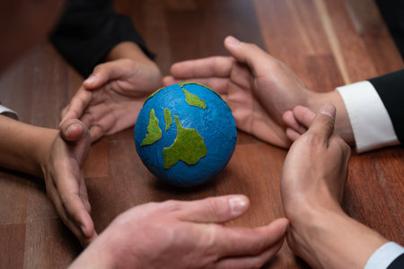 Top view business people holding Earth together in synergy as team building to utilize eco regulation for environmental protection by reducing CO2 emission to save Earth. Quaintの写真素材