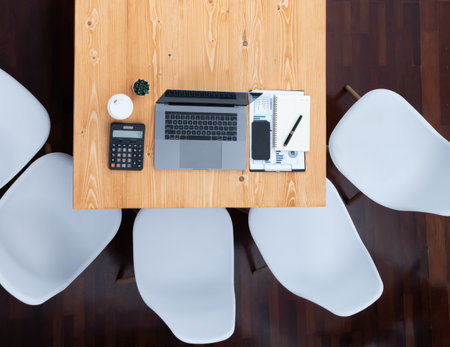 Panoramic top view of organized office workspace with laptop and analyzed financial data. Modern and...