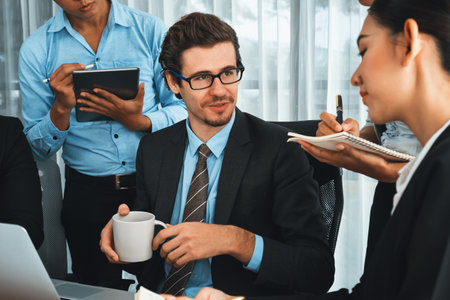 Diverse of business people from various ethnic group working in modern office environment. Productive and multi ethnic office workers engage in discussion for strategic business marketing. Habilimentの写真素材
