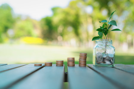 Concept of sustainable money growth investment with glass jar filled with money savings and coin...