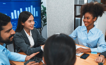 Multiracial analyst team use BI dashboard data to analyze financial report on meeting table. Group of diverse business people utilize data analysis by FIntech for business marketing decision. Concordの写真素材