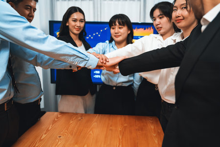 Multiethnic business people holding jigsaw pieces and merge them together as effective solution solving teamwork, shared vision and common goal combining diverse talent. Meticulousの写真素材