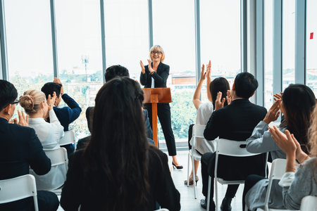 Group of business people meeting in a seminar conference . Audience listening to instructor in employee education training session . Office worker community summit forum with expert speaker . Jivyの写真素材