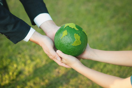 Businessman hand giving Earth globe to little boy as Earth day concept as corporate social responsible to contribute greener environmental protection for sustainable future generation. Gyreの写真素材