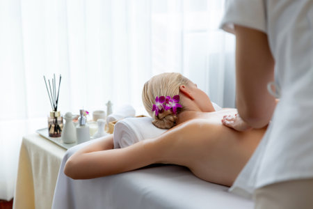 Caucasian woman customer enjoying relaxing anti-stress spa massage and pampering with beauty skin recreation leisure in day light ambient salon spa at luxury resort or hotel. Quiescentの写真素材