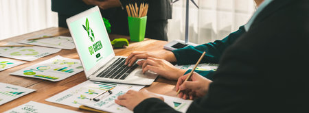 Go green ecology awareness campaign display on laptop on eco-friendly company meeting with business people implementing environmental protection for clean and sustainable future ecology. Trailblazingの写真素材