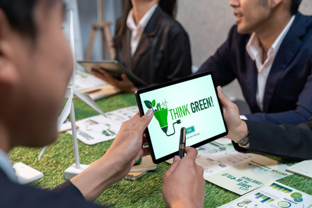 Diverse group of business people planning business marketing with environmental responsibility for greener ecology. Productive teamwork contribute natural preservation and sustainable future. Quaintの写真素材