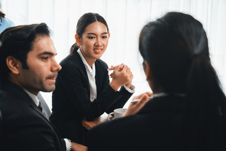 Diverse of business people from various ethnic group working in modern office environment. Productive and multi ethnic office workers engage in discussion for strategic business marketing. Meticulousの写真素材