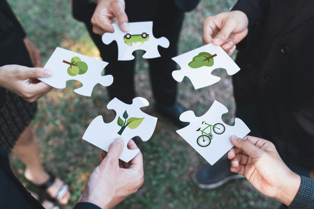 Business people or corporate partnership joining ECO friendly idea puzzle of jigsaw together as...