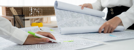 Worker, architect and engineer work on real estate construction project oratory planning with...