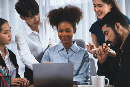 Happy diverse business people work together, discussing in corporate office. Professional and diversity teamwork discuss business plan on desk with laptop. Modern multicultural office worker. Concordの写真素材