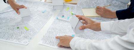 Worker, architect and engineer work on real estate construction project oratory planning with...