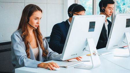 Business people wearing headset working in office to support remote customer or colleague. Call center, telemarketing, customer support agent provide service on telephone video conference call. Jivyの写真素材