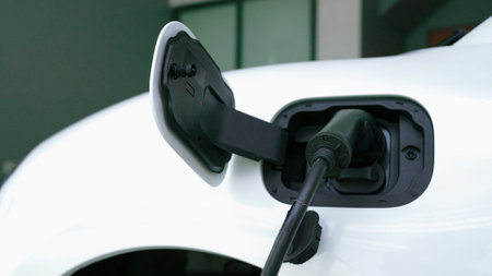 Home charging station providing sustainable, renewable source of power for electronic vehicle, EV cars at home for progressive modern lifestyle. Eco-friendly hybrid electro and petrol vehicle battery.の写真素材