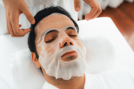 Serene modern daylight ambiance of spa salon, woman customer indulges in rejuvenating with facial skincare mask. Facial skin treatment and beauty cosmetology procedure for face. Quiescentの写真素材