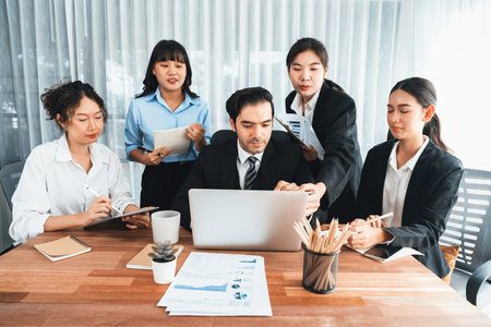 Diverse of business people from various ethnic group working in modern office environment. Productive and multi ethnic office workers engage in discussion for strategic business marketing. Meticulousの写真素材