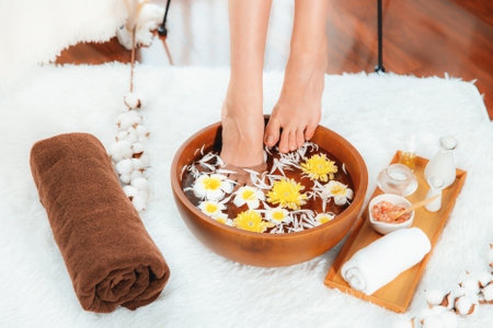 Woman indulges in blissful foot massage at luxurious spa salon while masseur give reflexology therapy in gentle day light ambiance resort or hotel foot spa. Quiescentの写真素材