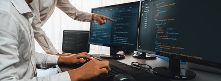 Software development team working together in office, coding script display on computer monitor....