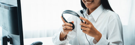 Business people wearing headset working in office to support remote customer or colleague. Call center, telemarketing, customer support agent provide service on telephone video conference oratory callの写真素材